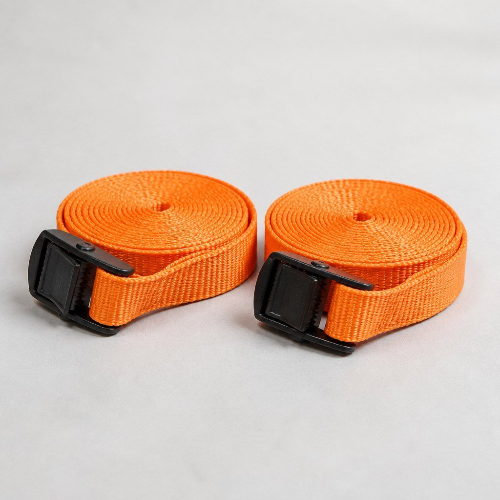 Pair of orange 15-foot cam-buckle cargo straps coiled on a workbench