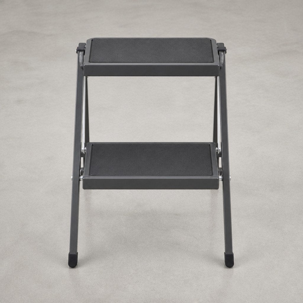 Compact folding steel step stool open on a shop floor